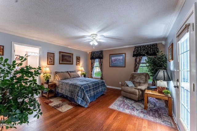 bedroom featuring ornamental molding, multiple windows, and wood finished floors