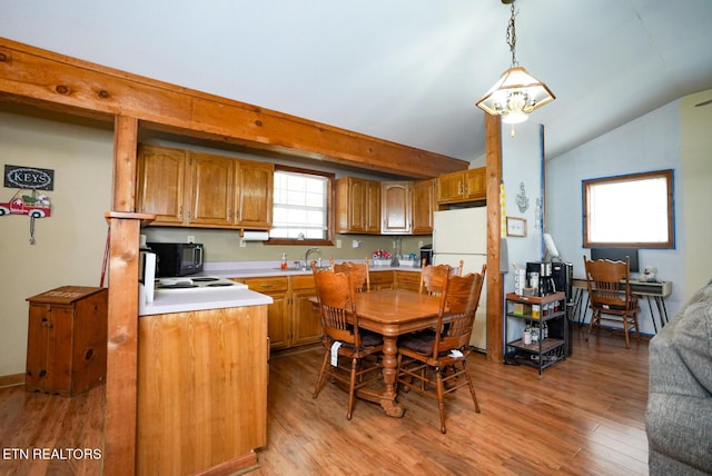 1435 Old Chisholm Trl, Dandridge, TN 37725 - kitchen featuring vaulted ceiling, freestanding refrigerator, brown cabinetry, light countertops, and black microwave