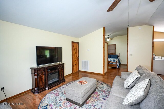 1435 Old Chisholm Trl, Dandridge, TN 37725 - living room featuring ceiling fan, washer / dryer, wood finished floors, lofted ceiling, and baseboards