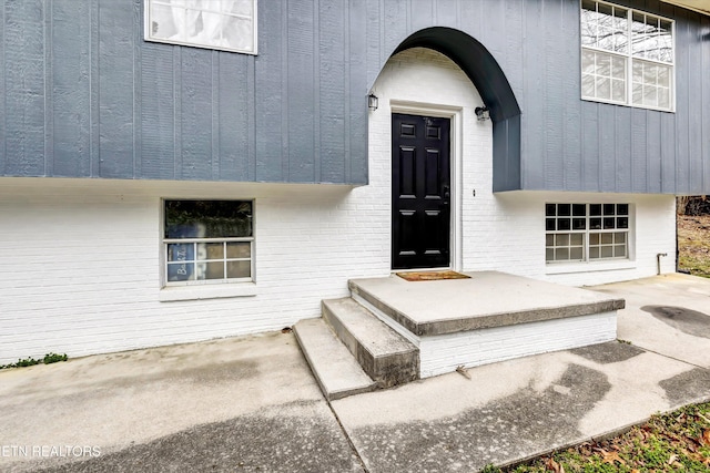 view of exterior entry with brick siding