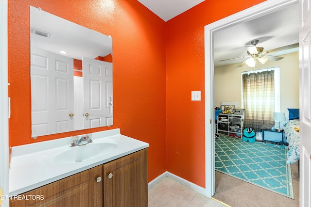 bathroom with vanity, baseboards, and ceiling fan