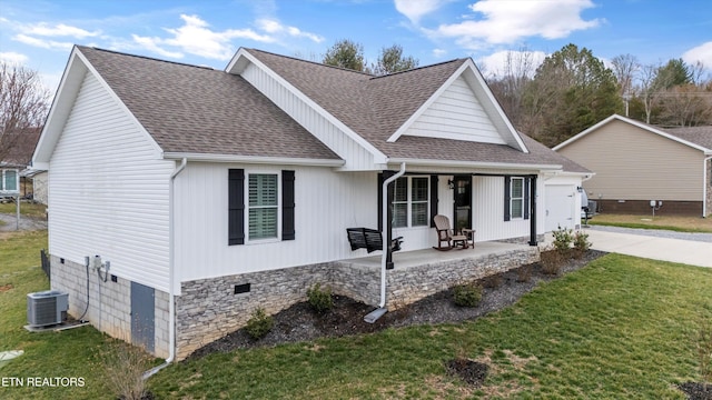 view of front of property featuring central AC unit, driveway, roof with shingles, covered porch, and a front lawn