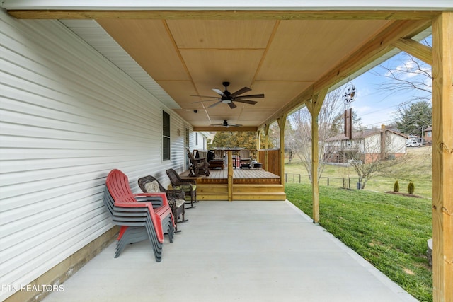 view of patio / terrace with ceiling fan and fence