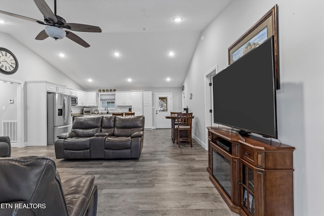 living area with visible vents, recessed lighting, wood finished floors, high vaulted ceiling, and a ceiling fan