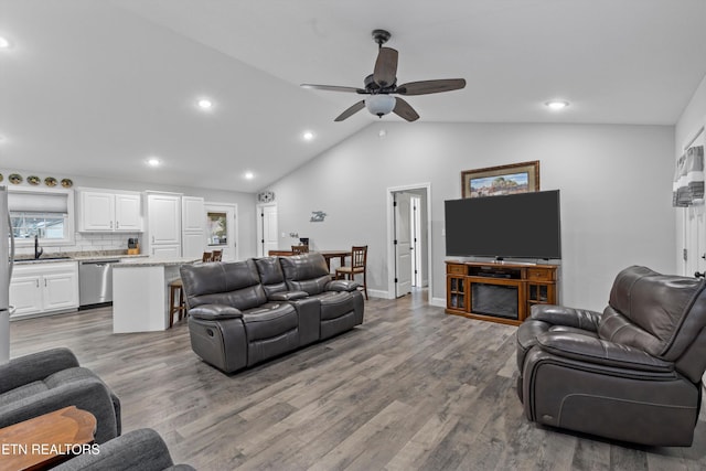 living area with vaulted ceiling, recessed lighting, wood finished floors, and ceiling fan