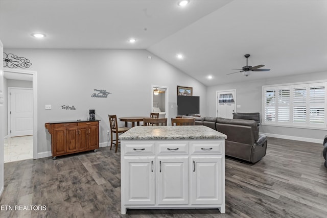 kitchen featuring lofted ceiling, white cabinets, dark wood-style floors, and ceiling fan