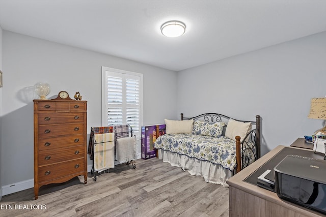 bedroom with light wood finished floors