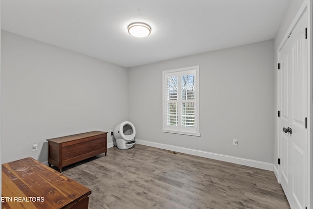 miscellaneous room featuring visible vents, wood finished floors, and baseboards