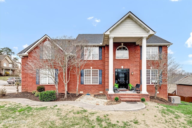 view of front of home featuring crawl space, brick siding, and a shingled roof