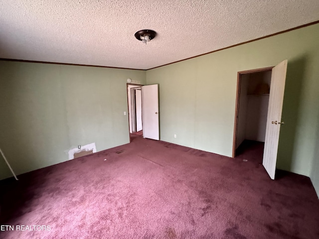 unfurnished bedroom with carpet floors, a closet, crown molding, and a textured ceiling