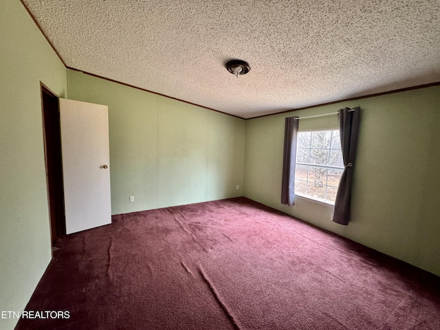 carpeted empty room with a textured ceiling and crown molding