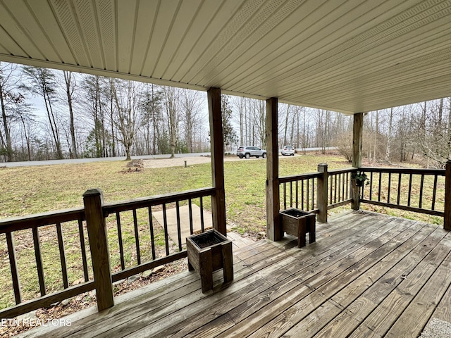 wooden deck with a lawn