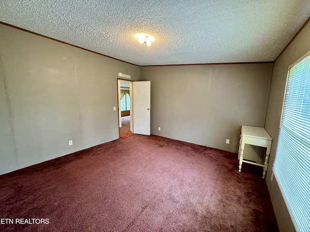 unfurnished bedroom featuring carpet flooring, a textured ceiling, and crown molding