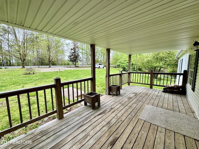 wooden terrace with a lawn