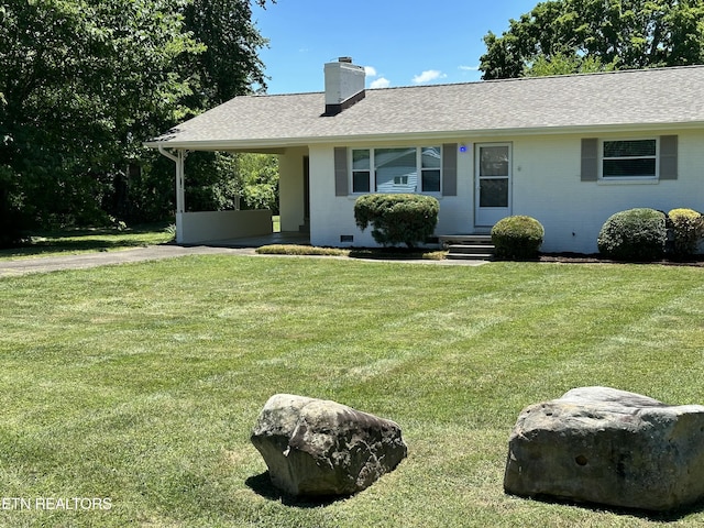 ranch-style house with a shingled roof, a chimney, an attached carport, crawl space, and a front yard