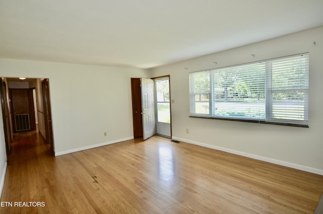 unfurnished room featuring light wood-style flooring and baseboards