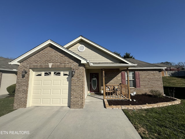 single story home featuring covered porch, brick siding, a garage, and driveway