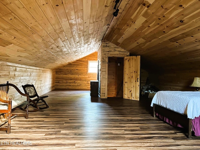 bedroom with wood finished floors, lofted ceiling, wood walls, and wooden ceiling