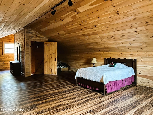 bedroom featuring lofted ceiling, wooden walls, wood finished floors, and wooden ceiling