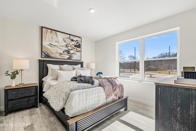 bedroom featuring baseboards and wood finished floors