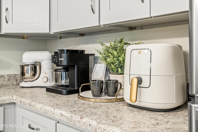 kitchen featuring light countertops and white cabinets