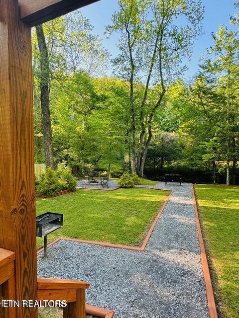 view of home's community featuring a patio area and a lawn