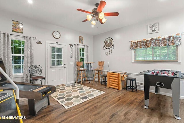 interior space with ceiling fan, visible vents, plenty of natural light, and wood finished floors