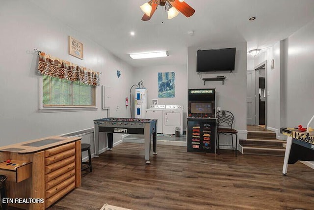 interior space featuring washing machine and dryer, water heater, ceiling fan, and wood finished floors