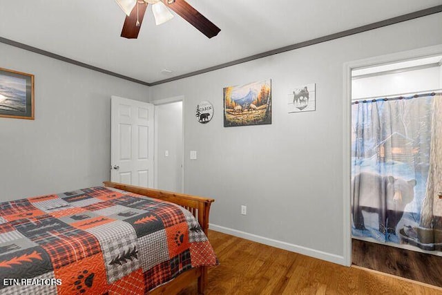 bedroom featuring ceiling fan, ornamental molding, wood finished floors, and baseboards