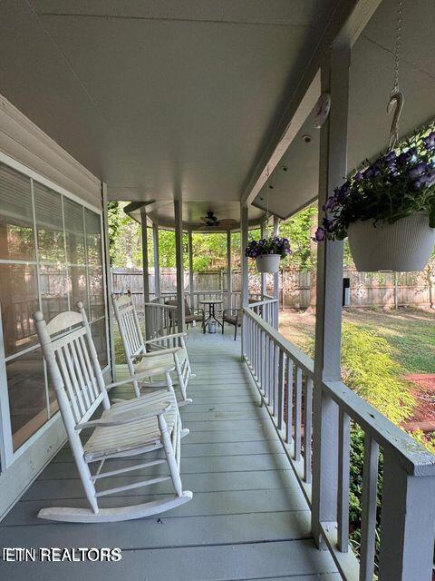 wooden deck with a porch and fence