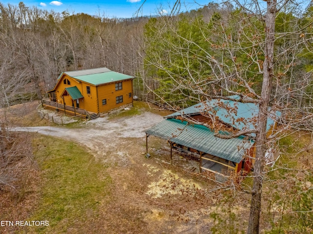 drone / aerial view with a wooded view