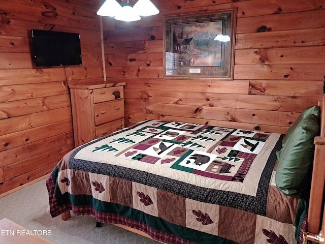 bedroom featuring wood walls and carpet flooring