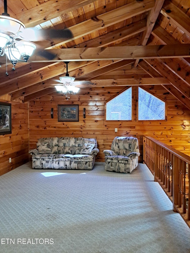 interior space featuring lofted ceiling with beams, wooden ceiling, wood walls, carpet flooring, and a ceiling fan