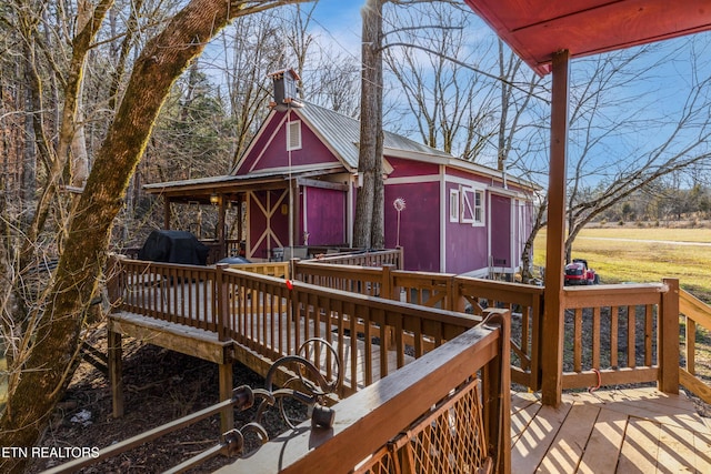 wooden terrace featuring area for grilling