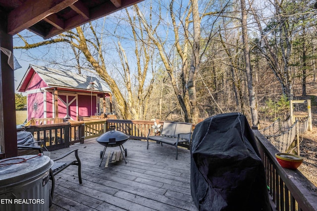 deck with an outbuilding and area for grilling