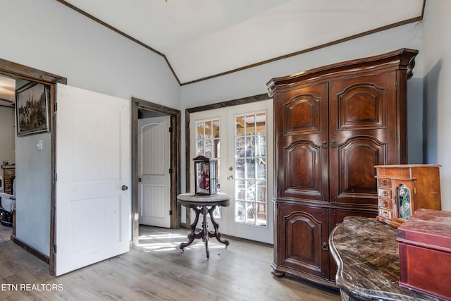 sitting room with vaulted ceiling, french doors, light wood finished floors, and baseboards