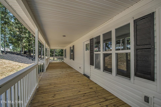 wooden terrace with a porch