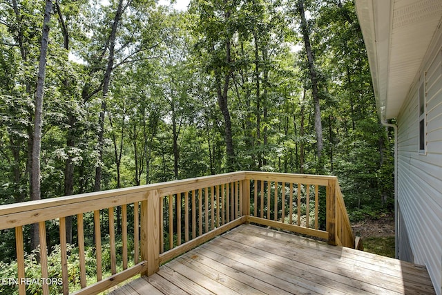 wooden deck featuring a wooded view