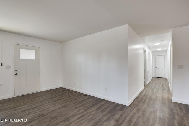 foyer featuring dark wood-style floors and baseboards