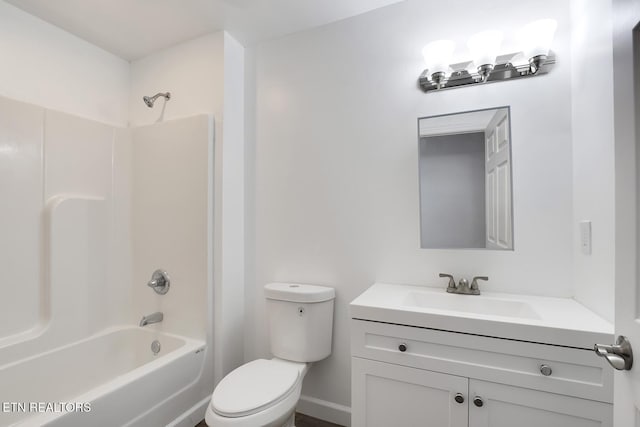 bathroom featuring vanity, toilet, and bathing tub / shower combination