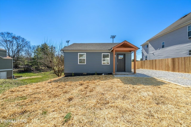 view of front of house with a front lawn and fence