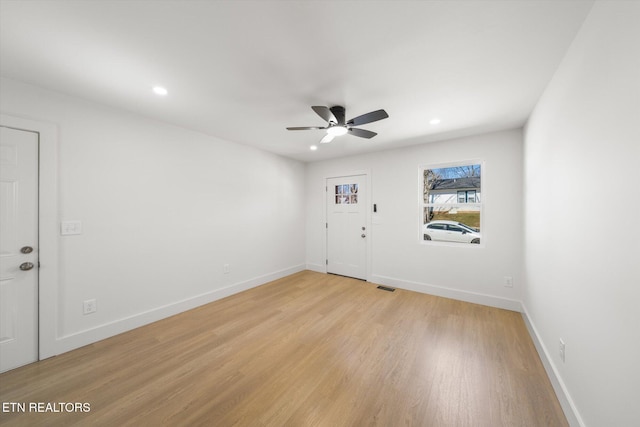 interior space with light wood finished floors and baseboards