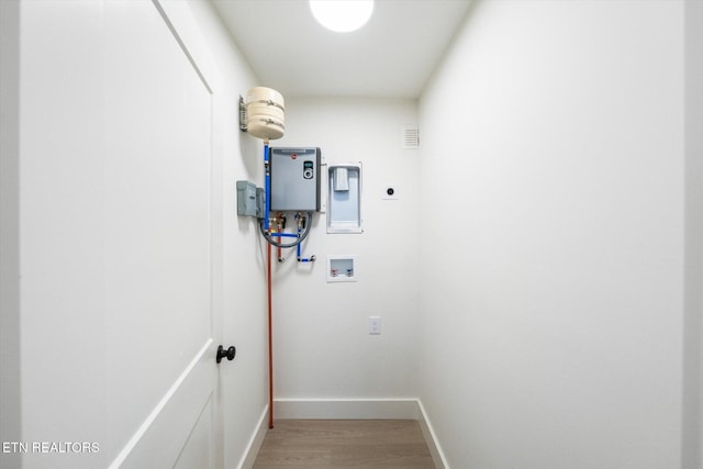 washroom featuring washer hookup, hookup for an electric dryer, wood finished floors, laundry area, and baseboards