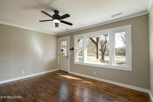 entryway with dark wood finished floors, visible vents, baseboards, and ornamental molding