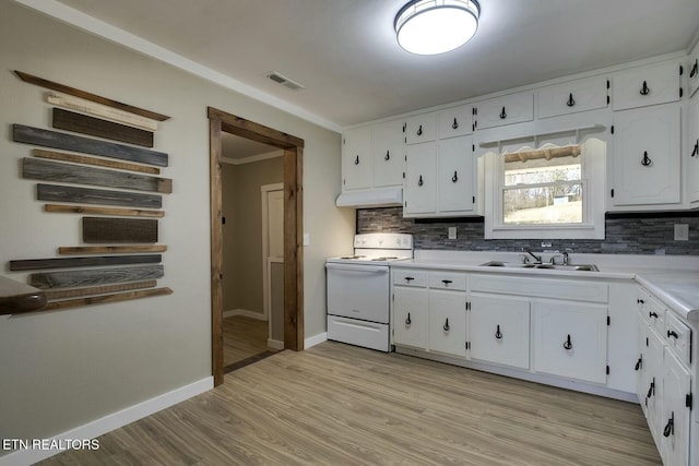 kitchen featuring white electric range oven, visible vents, a sink, white cabinets, and tasteful backsplash