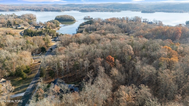 aerial view with a forest view and a water view