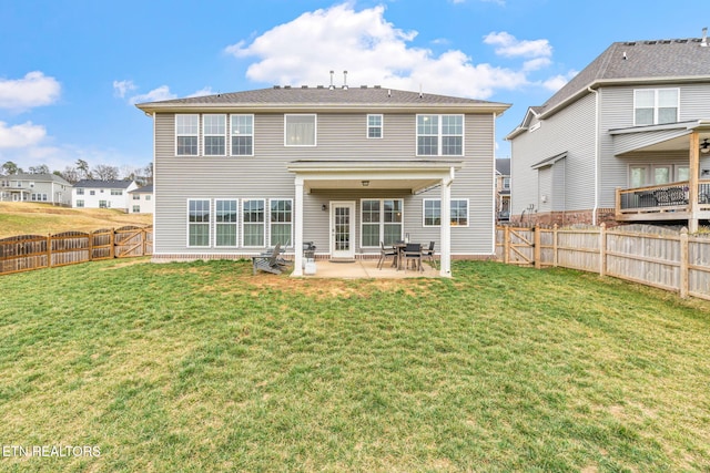 back of property with a yard, a patio, and a fenced backyard