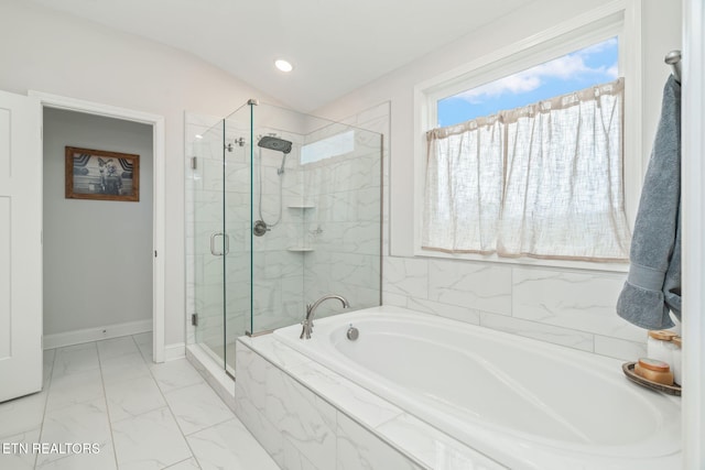 bathroom with a stall shower, marble finish floor, a garden tub, and baseboards