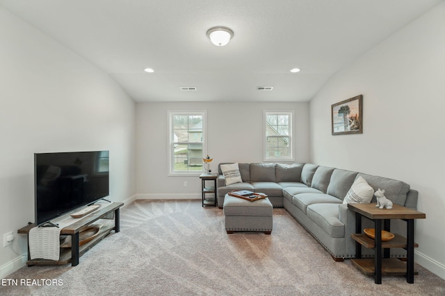 carpeted living area with baseboards, visible vents, vaulted ceiling, and recessed lighting