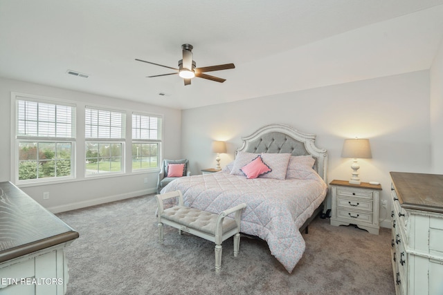 bedroom featuring carpet floors, baseboards, visible vents, and ceiling fan